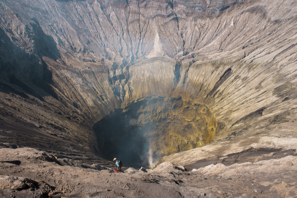 local man walking inside the crater of mount bromo indonesia